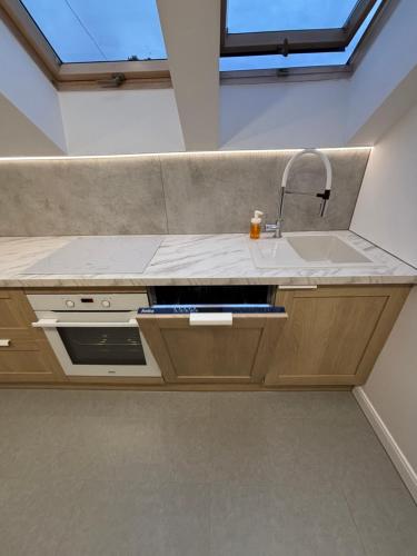 a kitchen with a sink and a counter top at Suwałki Kościuszki Centrum in Suwałki