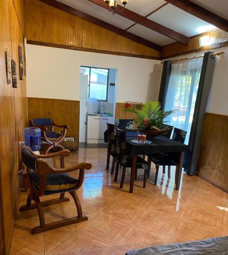 a dining room with a table and chairs at Cabañas Hua'ai Village in Hanga Roa