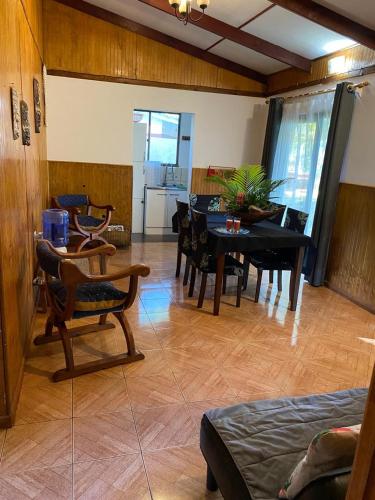 a living room with a table and a dining room at Cabañas Hua'ai Village in Hanga Roa