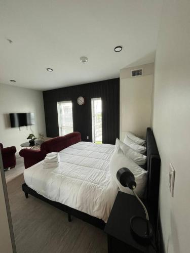 a bedroom with a large bed with a lamp on it at Red Velvet Studio in Des Moines