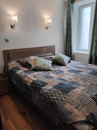 a bed with two pillows on it in a bedroom at Auberge à la croisée gîte "La Marne" in Saint-Barthélemy