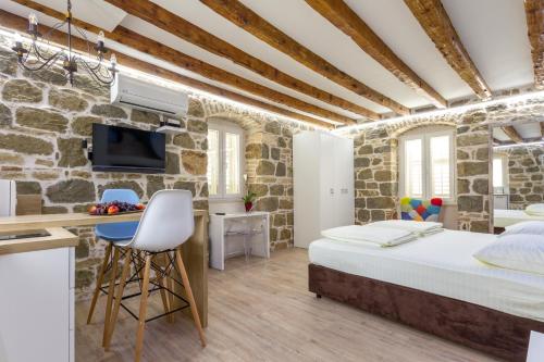 a bedroom with a bed in a stone walled room at Studio Central in Split