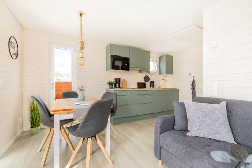 a living room with a couch and a table at Hausboot MeerZeit an der Ostsee in Stralsund