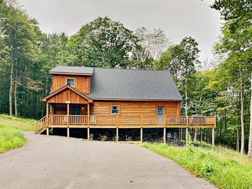 a large wooden cabin in the middle of a forest at Almost Eden in McHenry