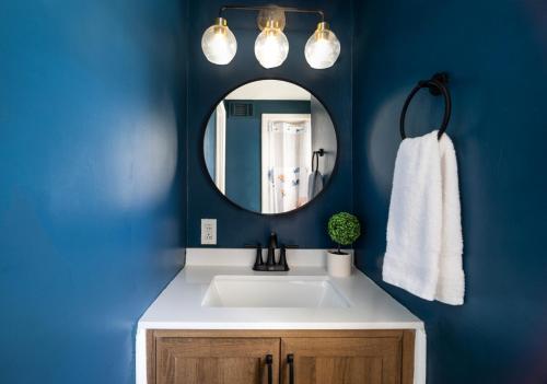 a bathroom with a white sink and a mirror at Savannah Retreat with Pool,Golf,Hot tub, Sleeps 14 in Savannah