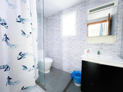 a bathroom with a shower curtain and a sink at CARIBBEAN SEA Hotel BEACH Vacation rental studios LONG TERM POOL SPA in Punta Cana