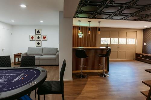 a clubhouse with a poker table and a couch at Drift Haus 4 and half BR Mountain Lodge in Windham