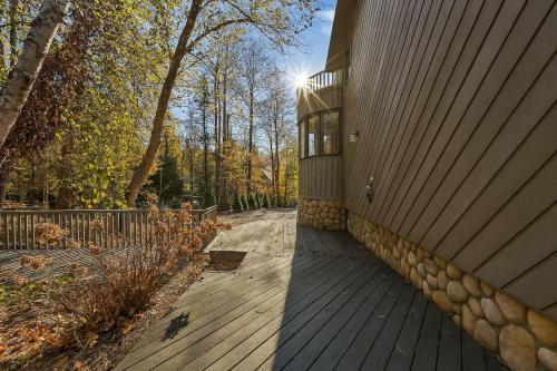 a house with a wooden deck next to a building at Drift Haus 4 and half BR Mountain Lodge in Windham