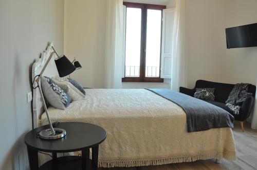 a bedroom with a bed and a lamp on a table at AL 32 B&B in Massa Marittima