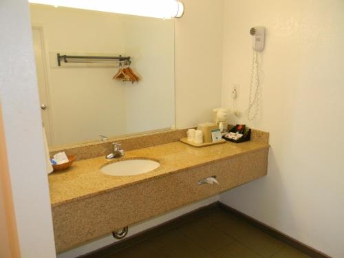 a bathroom with a sink and a mirror at Rodeway Inn Alameda-Oakland in Alameda