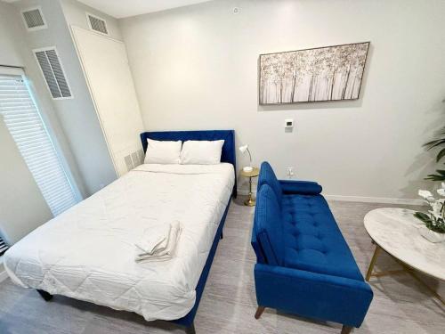 a bedroom with a blue bed and a blue chair at Azure Oasis Studio in Des Moines