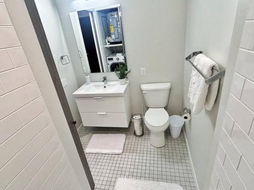 a small bathroom with a toilet and a sink at Azure Oasis Studio in Des Moines