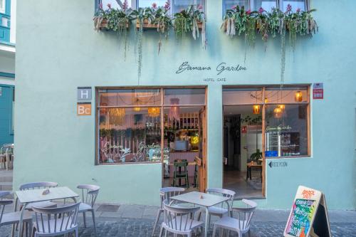 a restaurant with tables and chairs in front of a building at Banana Garden La Palma in Santa Cruz de la Palma