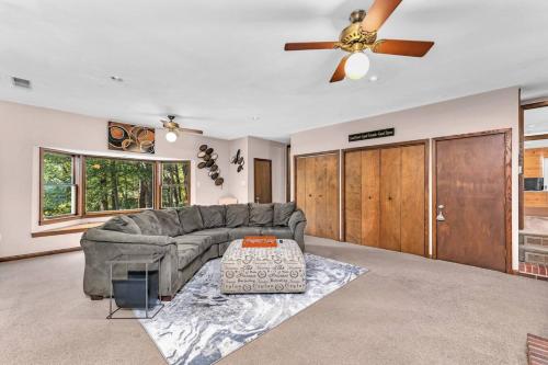 a living room with a couch and a ceiling fan at Spacious Augusta Retreat Near Augusta National in Augusta