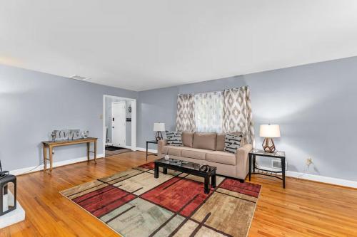 a living room with a couch and a table at Spacious Augusta Retreat Near Augusta National in Augusta