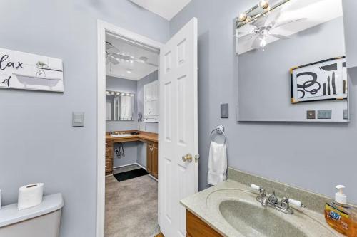 a bathroom with a sink and a toilet at Spacious Augusta Retreat Near Augusta National in Augusta