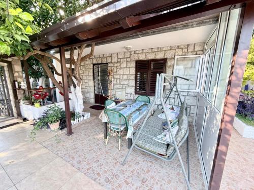 ヘルツェグ・ノヴィにあるApartment CEPICのパティオにはしごや椅子のあるポーチ