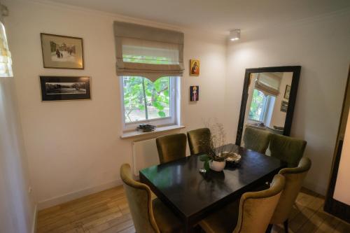 a dining room with a table and chairs at WieloDom - kryjówka na wsi in Wielogóra