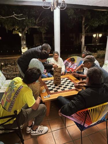 a group of people sitting around a table playing chess at Glamping La Cima in San Gil