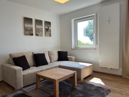 a living room with a couch and a coffee table at Fewo Uferglück in Seebruck