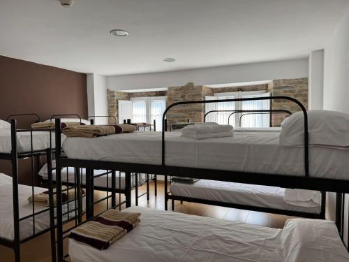 a group of bunk beds in a room at Albergue Internacional in Sarria