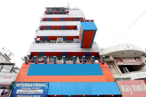 a building with a swimming pool in front of it at HOTEL O Vivek International Hotel in Jalandhar