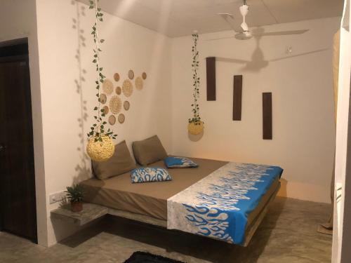 a bedroom with a bed and hanging baskets on the wall at Dana's Villa in Ahangama