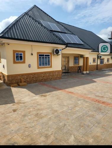 a building with solar panels on top of it at Ohio city hotel in Owerri