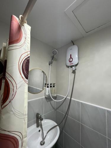a bathroom with a shower and a sink at Stayease Studio in Lapu Lapu City