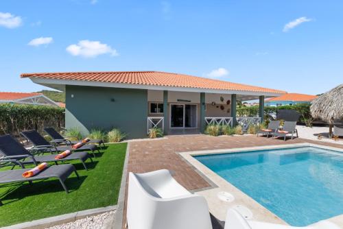 a villa with a swimming pool and lounge chairs at Casa Juno in Fontein