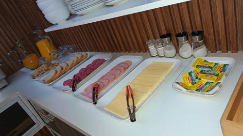 a counter with hot dogs and other food on it at Lodge Atacama Hostal in Copiapó
