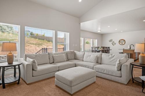a living room with a white couch and a table at Wasatch Peak Chateau Ro3, Pool, Hot Tub in Mountain Green