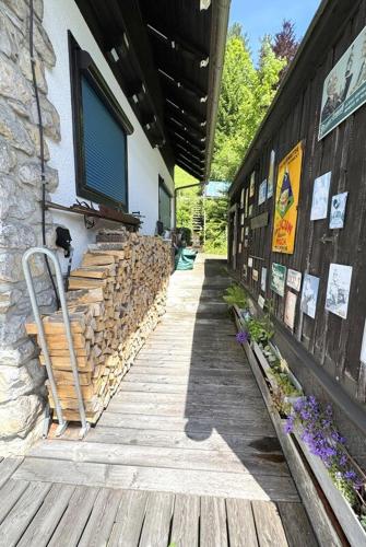 a building with a wooden walkway next to a building at Haus Anton in Sankt Aegyd am Neuwalde