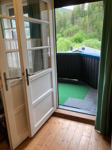 an open door to a balcony with a green yard at Haus Anton in Sankt Aegyd am Neuwalde