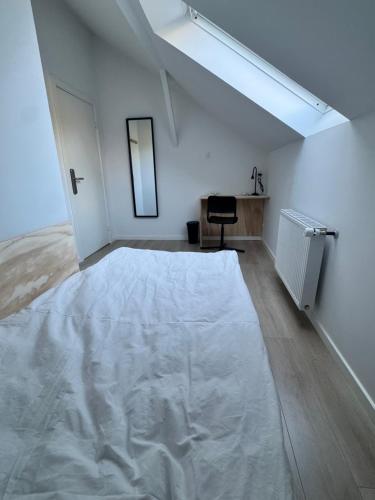 a large white room with a desk and a mirror at Vognstrupgaard in Silkeborg