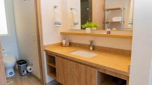 a bathroom with a sink and a mirror at Reserva Del Mar Apartamentos in Gaira