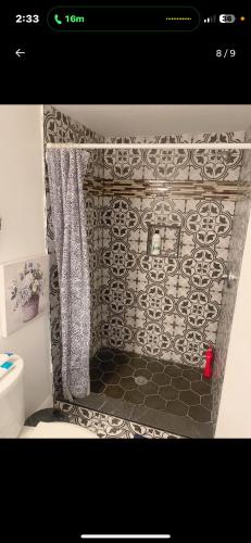 a bathroom with a black and white patterned wall at Brand new bedroom with Tv next JHU in Baltimore
