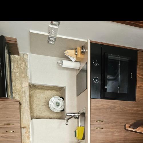 a bathroom with a sink and a door to a room at Katerinas sweet place studio 2 in Tsadha