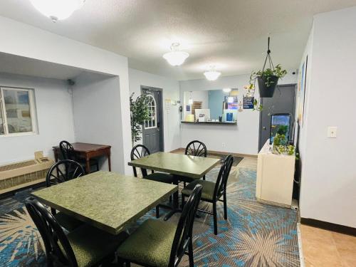 a dining room with two tables and chairs at Days Inn by Wyndham Jamestown in Jamestown