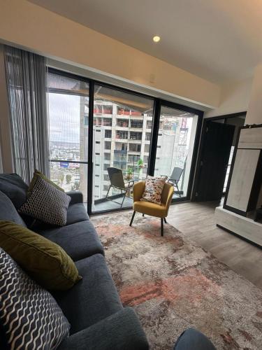 a living room with a couch and a chair at Adamant Toreo in Tijuana