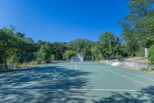 a tennis court with trees in the background at Le Chopin - Aix in Aix-en-Provence