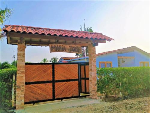 a wooden gate with a wooden fence at Cabaña Maria José in Moñitos