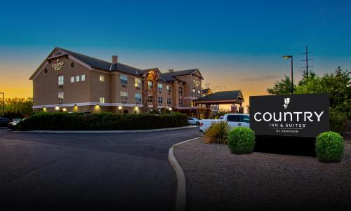 a building with a sign in front of a building at Country Inn & Suites by Radisson, Tucson City Center AZ in Tucson