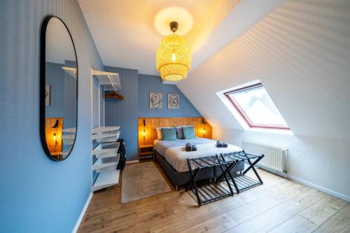 a bedroom with a bed and a window and a table at Über den Dächern von Witten bis 6P in Witten