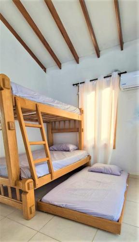 two bunk beds sitting inside of a room at Cabaña Maria José in Moñitos
