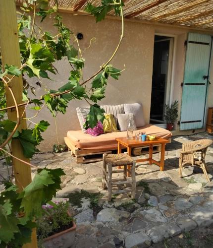 a patio with a couch and a table at CHAMBRE PRIVEE chez l'HABITANT SALLE d'eau WC Privatifs in La Saulce