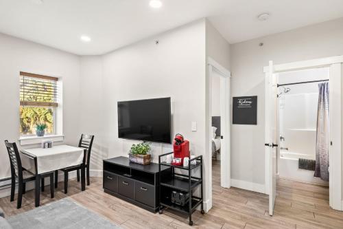 a living room with a dining table and a television at Downtown One Bedroom Apartment Fully Furnished in Great Falls