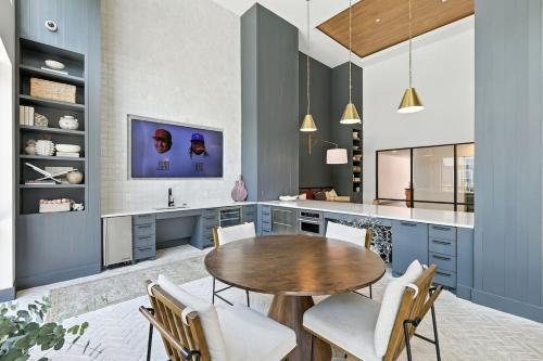 a kitchen with a wooden table and chairs at 101 Stylish Condo, Resort Amenities, Near Stockyards in Fort Worth