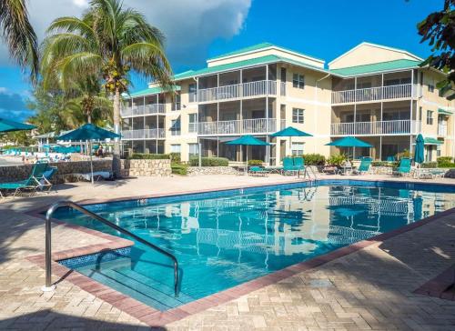 a swimming pool in front of a resort at Plantation Village #20 Condo in Seven Mile Beach