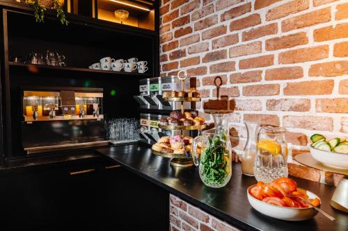 a kitchen with a counter with fruits and vegetables on it at Ambassador City Centre Hotel in Haarlem